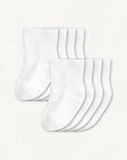 4-pack set of white baby crew socks with silicone grips on an off-white background