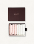Open box displaying 2 pairs of blush and 2 pairs of white baby socks with 'piggy's' branding on a white background.