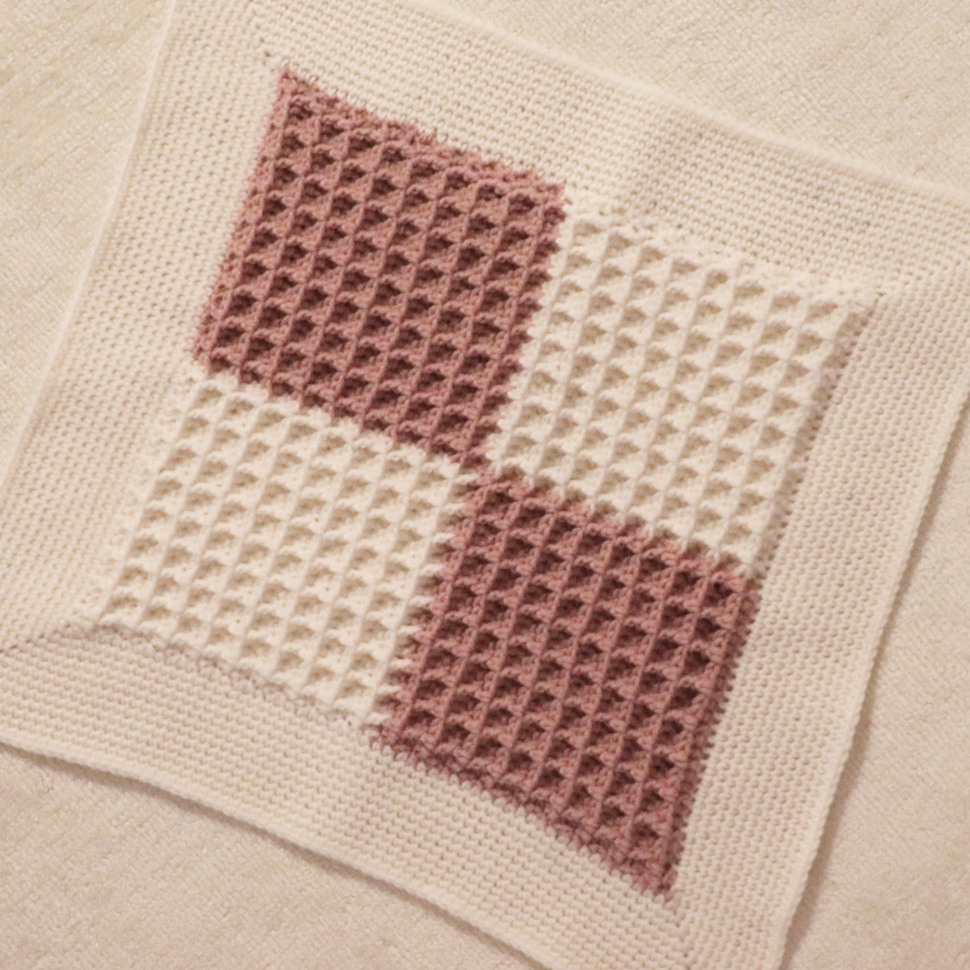 merino wool woven baby lovey blanket in dusty rose and bone checkered pattern