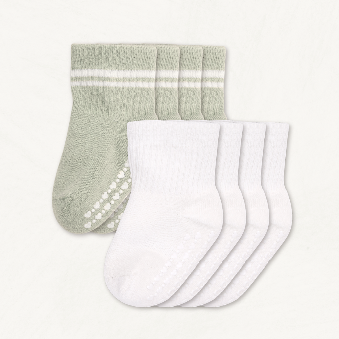 4-pack set of off-white and light sage baby crew socks with white stripes and silicone grips on an off-white background