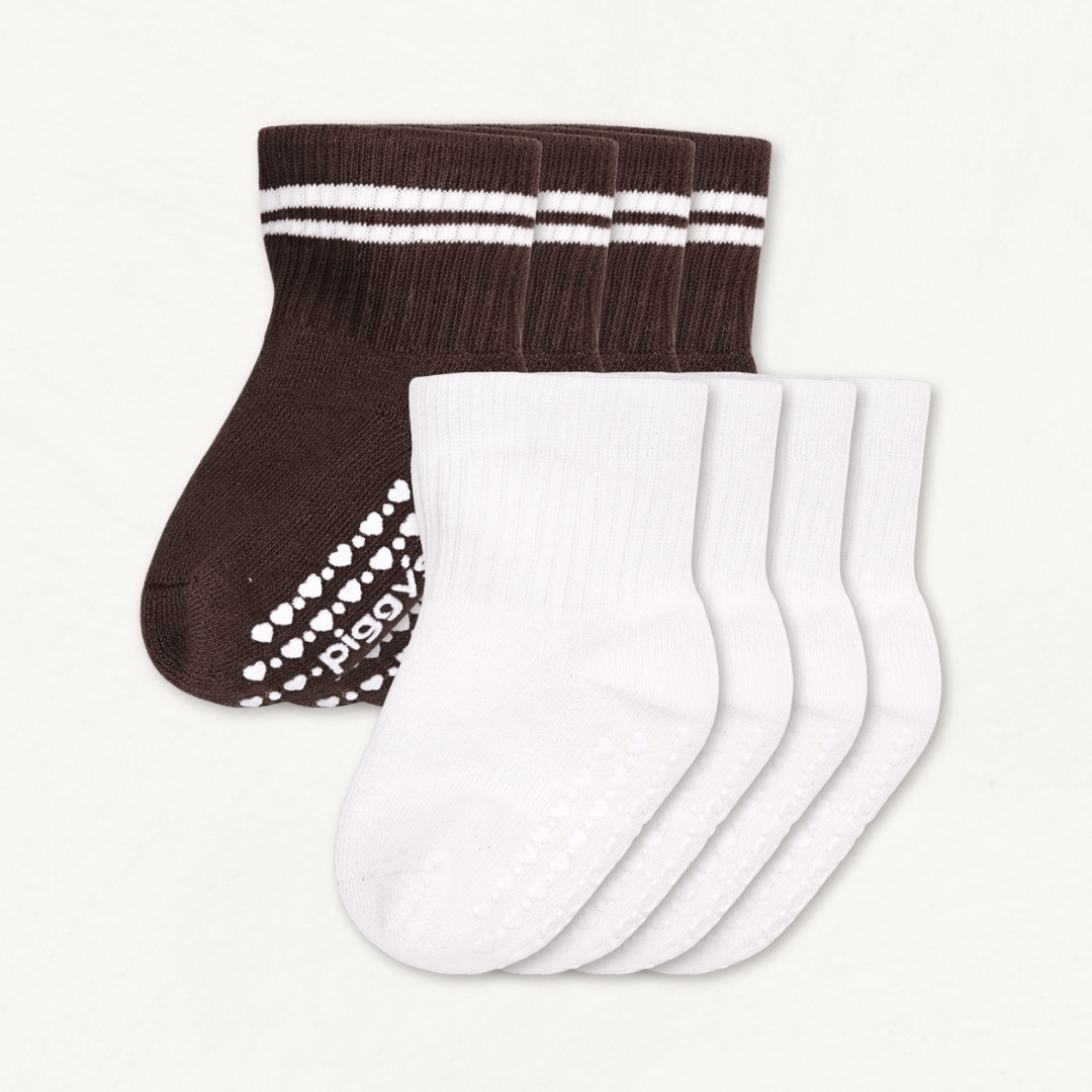 4-pack set of off-white and dark brown baby crew socks with white stripes and silicone grips on an off-white background