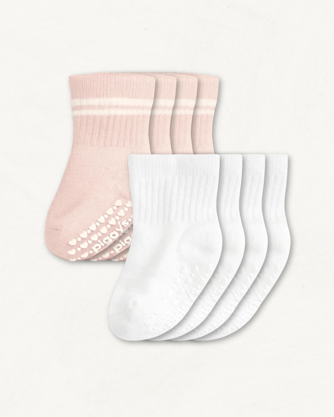 4-pack set of white and blush baby crew socks with silicone grips on an off-white background