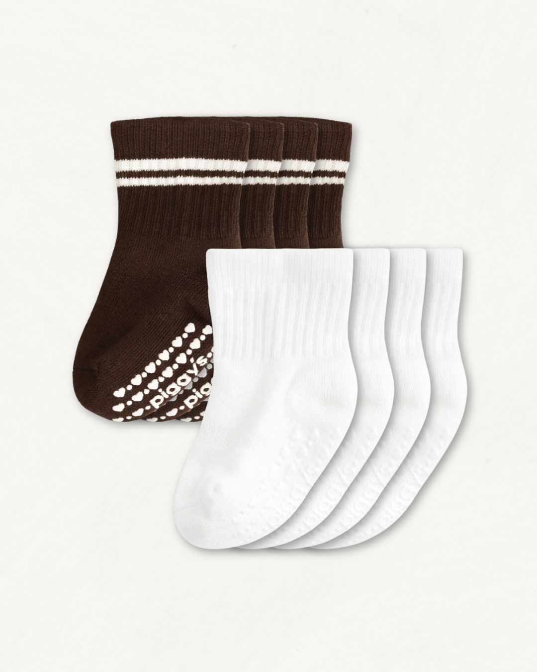4-pack set of white and espresso brown baby crew socks with silicone grips on an off-white background