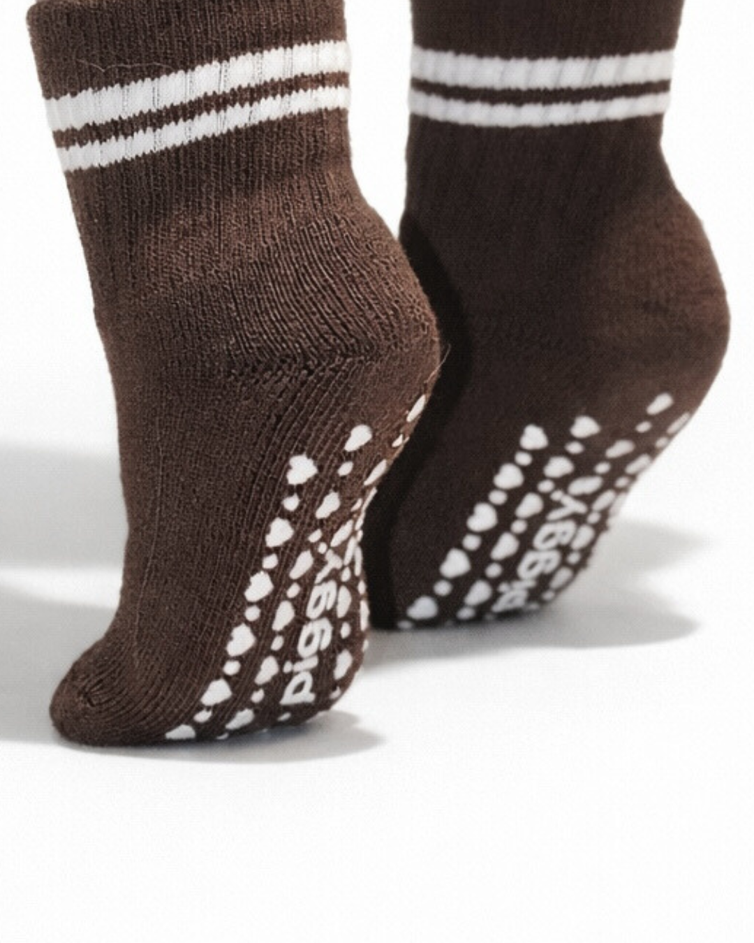 Espresso baby crew sock with heart patterned Piggy's grips on a white background