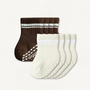 Set of off-white and dark brown baby crew socks with white stripes and silicone grips on an off-white background