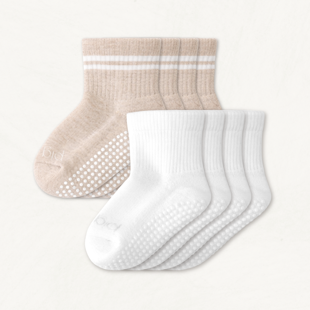 4-pack set of beige and white toddler crew socks on a light gray background