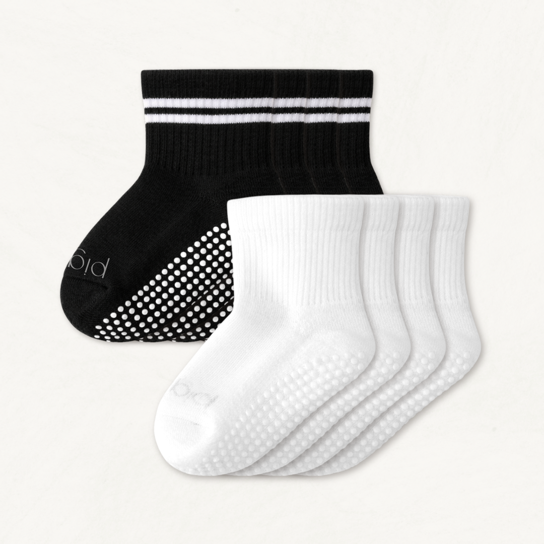 4-pack set of black and white toddler crew socks on a light gray background